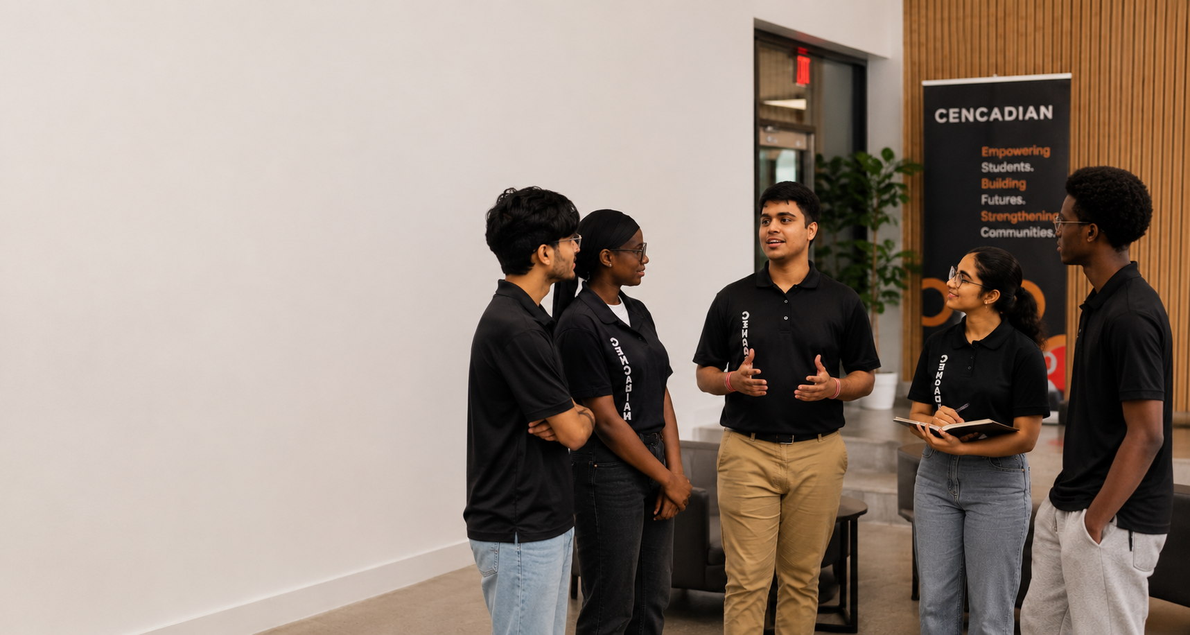 Cencadian team members collaborating around a laptop in a bright office