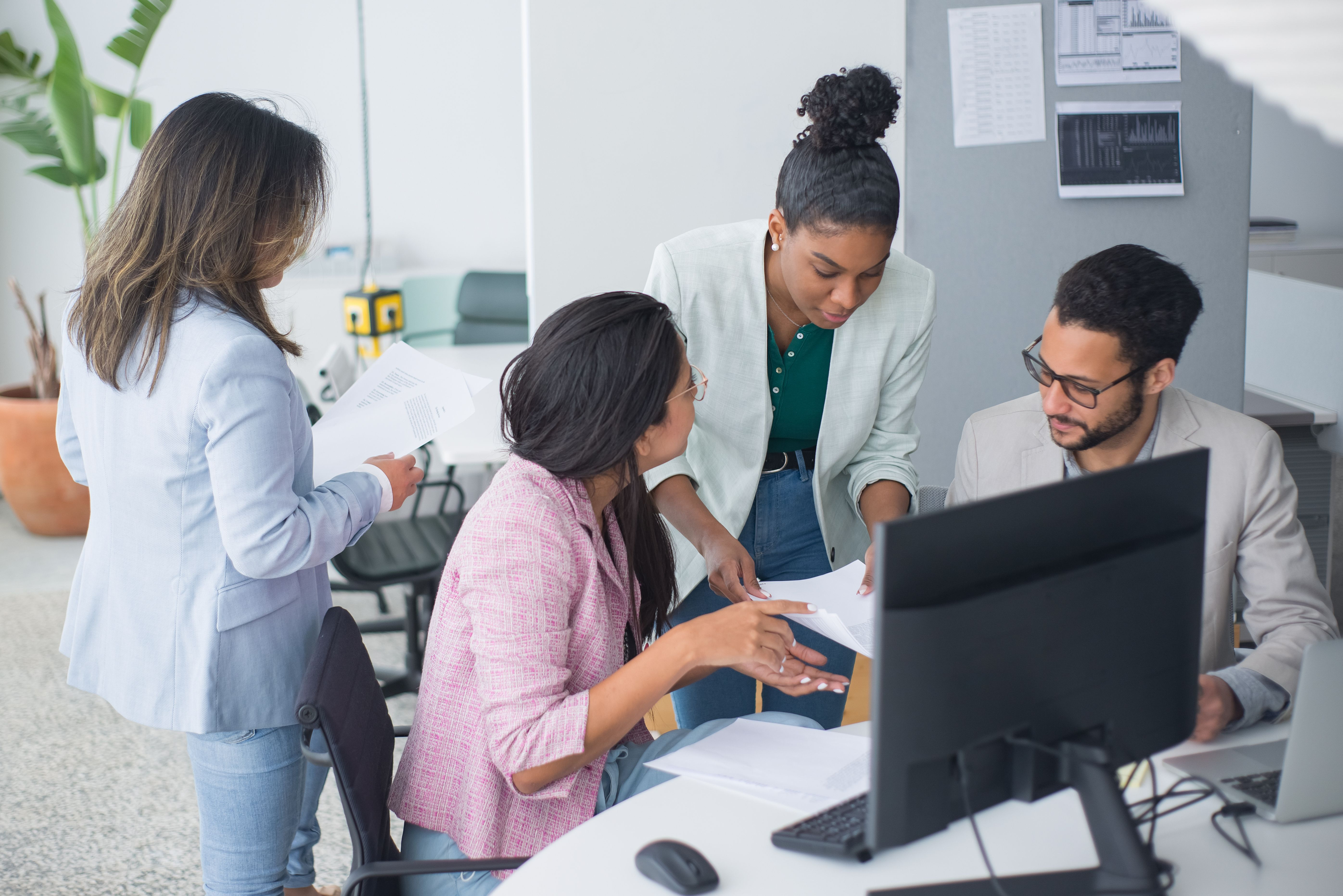 Team reviewing documents around an office desk
