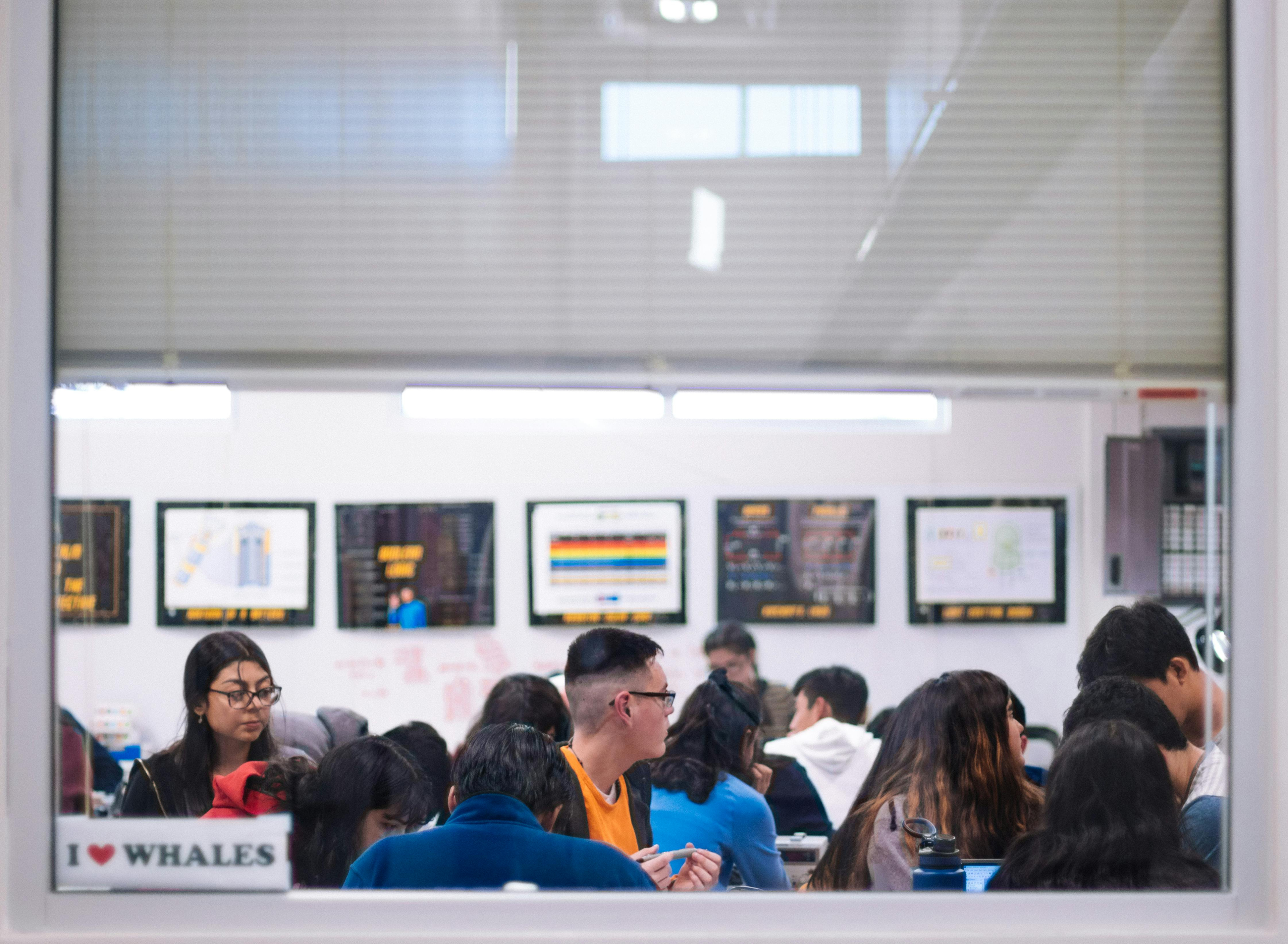 Students meeting in a busy community learning room