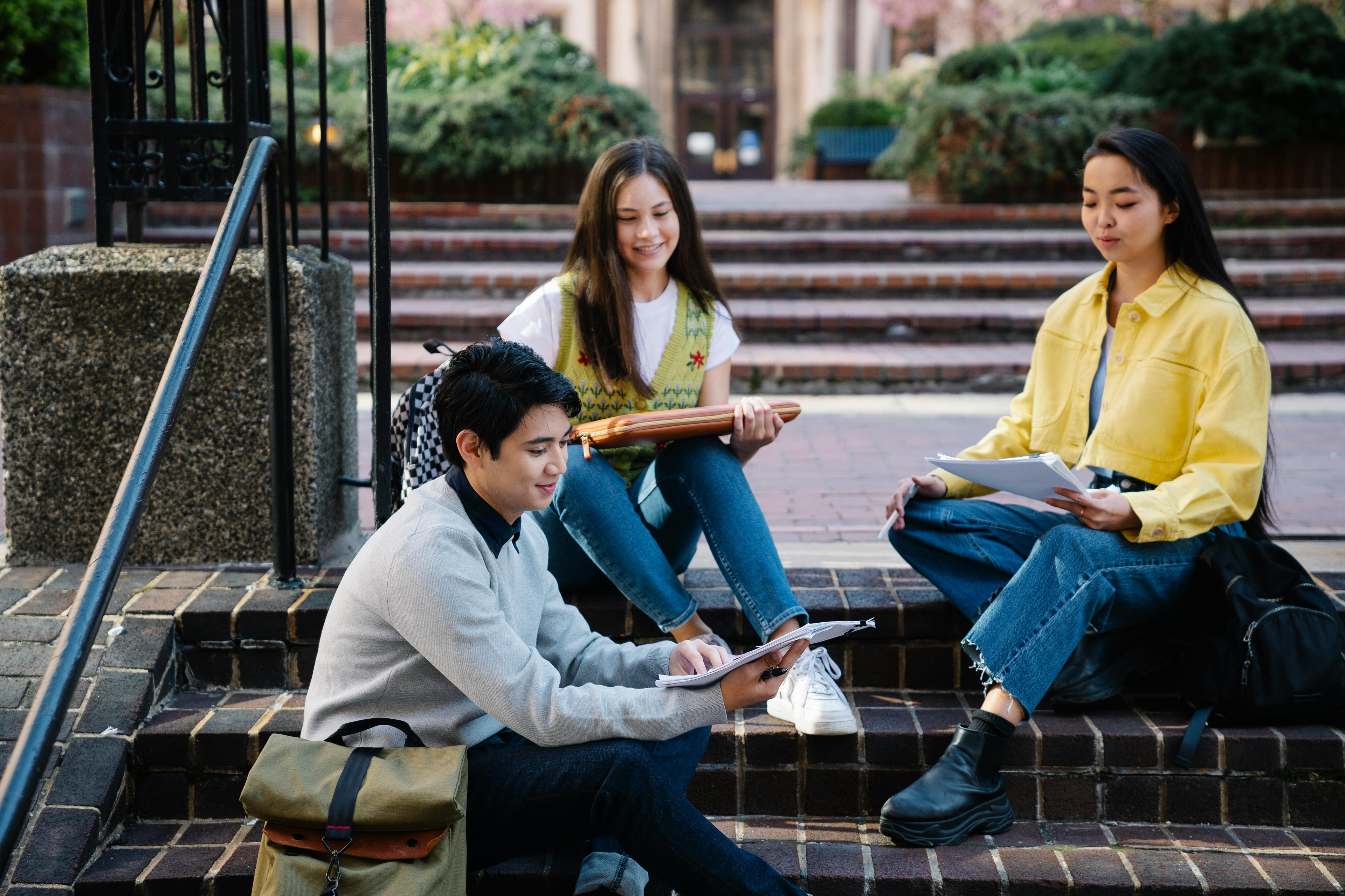Students collaborating outdoors on campus steps